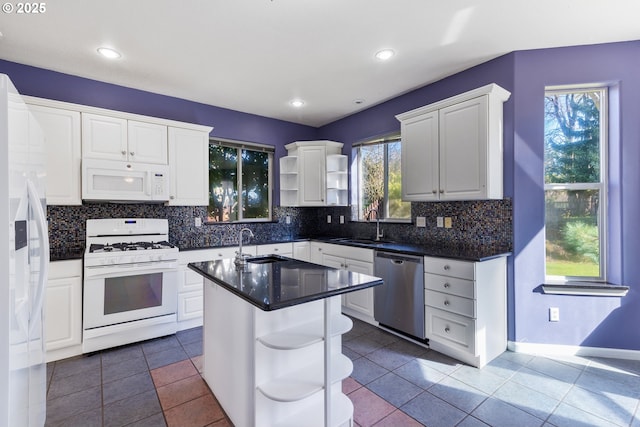 kitchen with white appliances, white cabinets, a sink, and open shelves