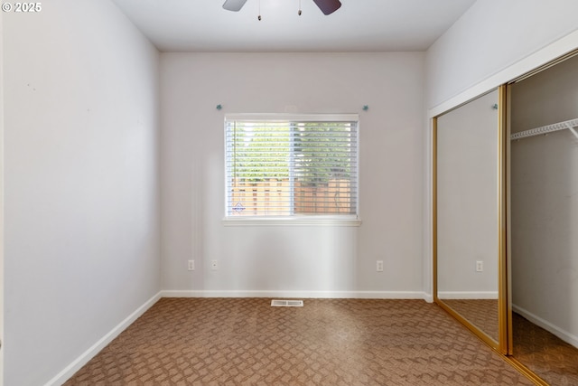 unfurnished bedroom featuring carpet floors, a closet, visible vents, and baseboards