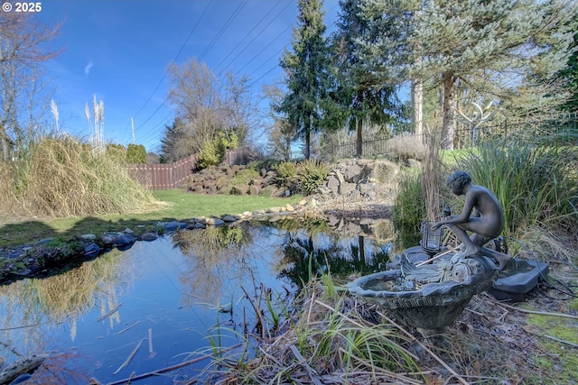 view of water feature with fence