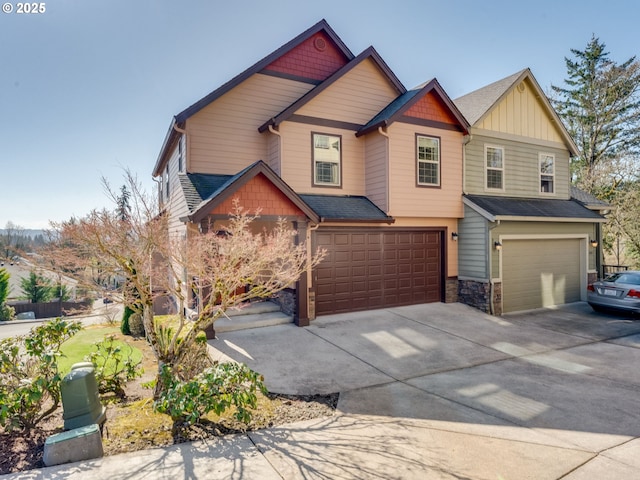 craftsman-style house featuring a garage, stone siding, a shingled roof, and concrete driveway