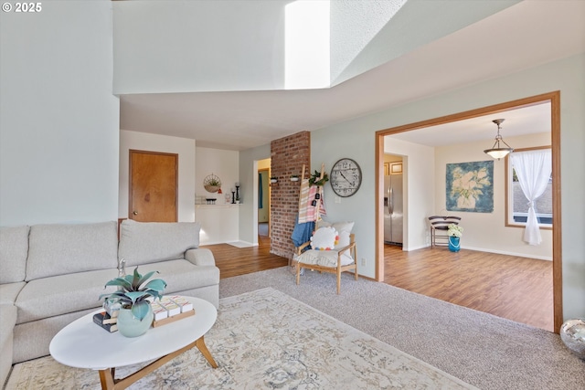 living room featuring hardwood / wood-style floors and a skylight