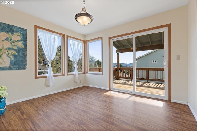 unfurnished room featuring wood-type flooring and a mountain view