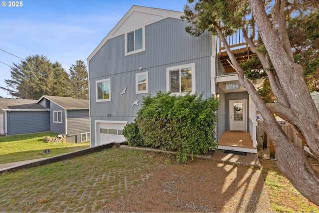 view of front of property with a garage and a front lawn