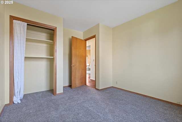 unfurnished bedroom featuring carpet floors and a closet