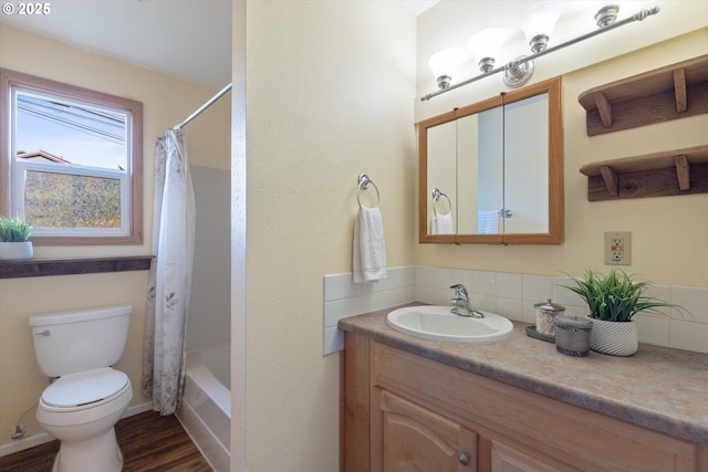 full bathroom with hardwood / wood-style flooring, vanity, toilet, and shower / bath combo with shower curtain