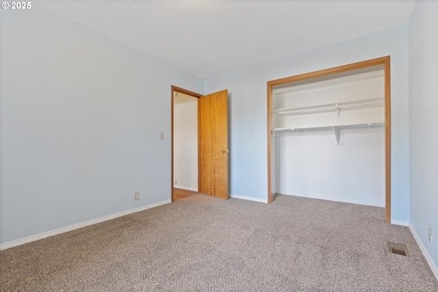 unfurnished bedroom featuring a closet and carpet flooring