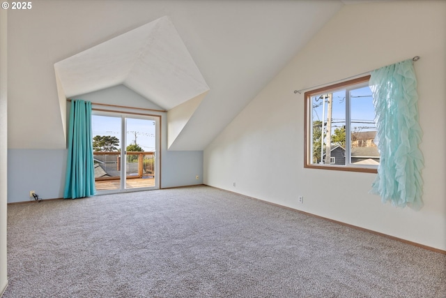 additional living space featuring lofted ceiling and carpet floors