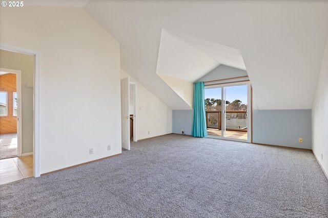 bonus room featuring light colored carpet and vaulted ceiling