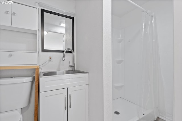 bathroom featuring vanity, toilet, and a shower with shower curtain