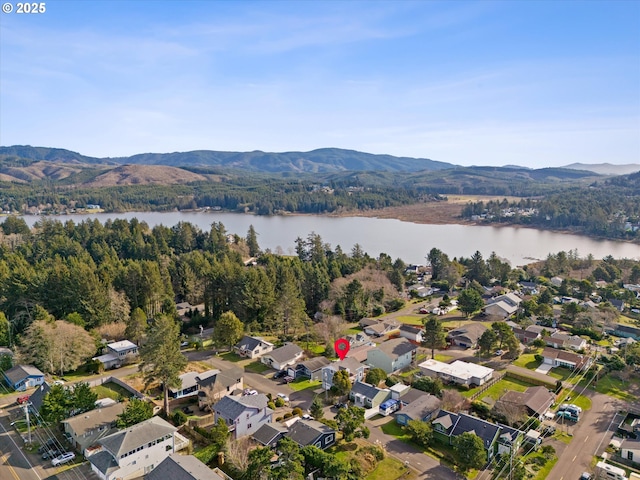 drone / aerial view with a water and mountain view