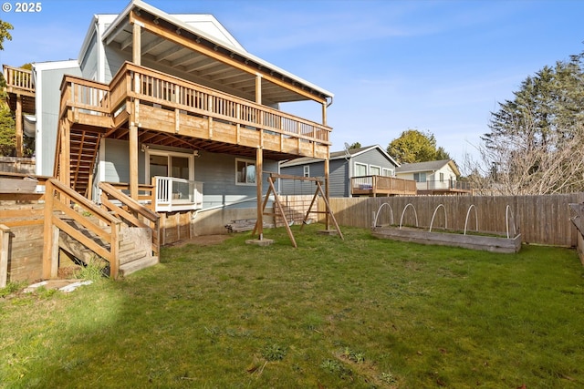 back of property featuring a wooden deck and a yard