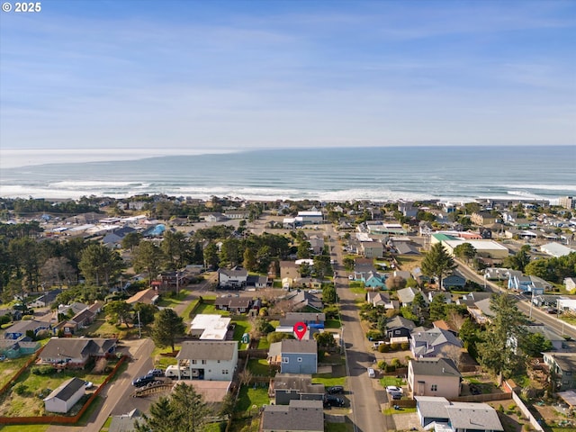 birds eye view of property featuring a water view and a beach view