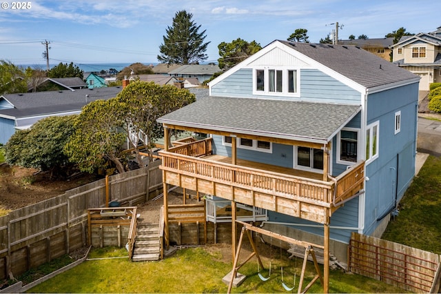 rear view of property featuring a deck