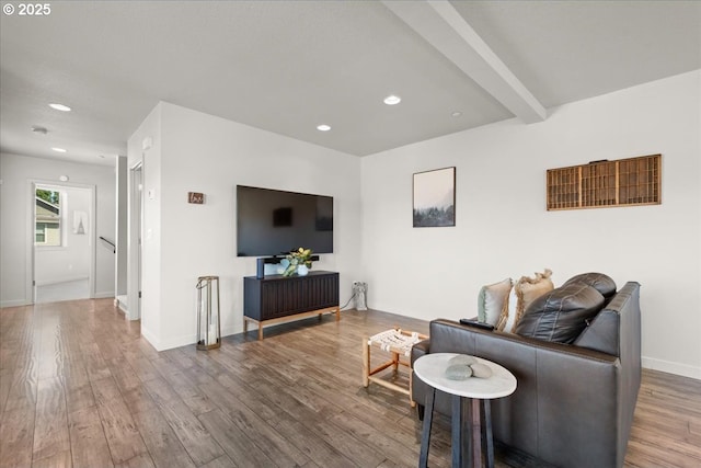 living room with beamed ceiling and wood-type flooring