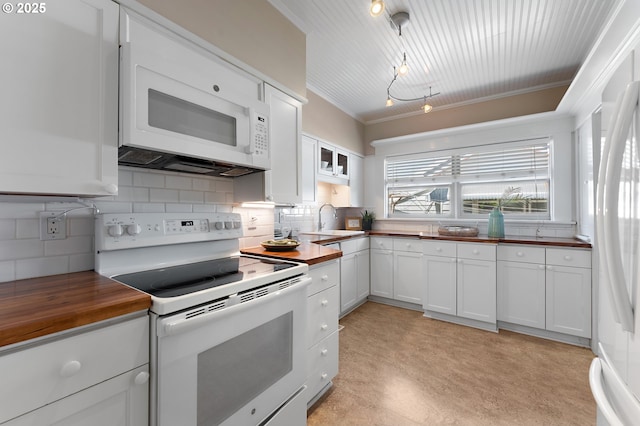 2804 NE 61st Ave, Portland, OR 97213 - kitchen featuring wooden counters, white appliances, a sink, tasteful backsplash, and white cabinetry