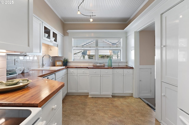 2804 NE 61st Ave, Portland, OR 97213 - kitchen featuring wood counters, a sink, white cabinetry, glass insert cabinets, and ornamental molding