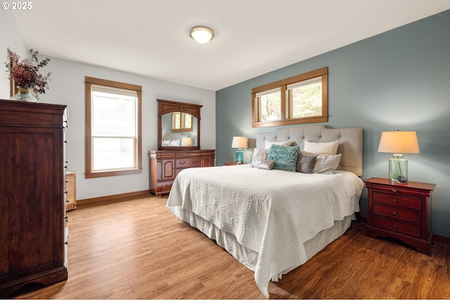 8866 Ocean Crest Ln, Manzanita, OR 97130 - bedroom featuring light wood-type flooring and multiple windows