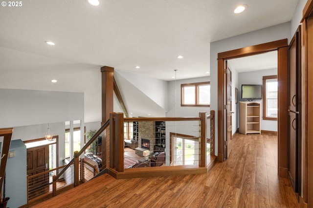 8866 Ocean Crest Ln, Manzanita, OR 97130 - hall with an upstairs landing, wood finished floors, and recessed lighting