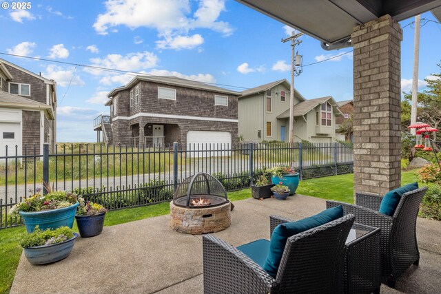 8866 Ocean Crest Ln, Manzanita, OR 97130 - view of patio featuring a fire pit and an attached garage