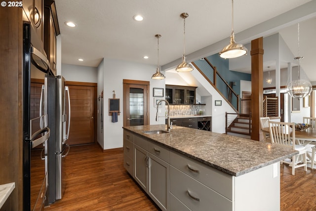 8866 Ocean Crest Ln, Manzanita, OR 97130 - kitchen featuring dark wood-type flooring, recessed lighting, pendant lighting, and freestanding refrigerator