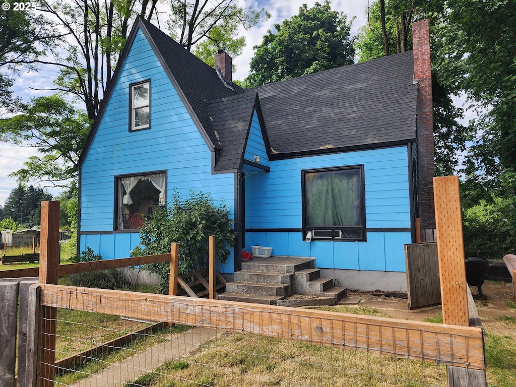 1315 Main St, Lyons, OR 97358 - view of front of home with a chimney and a shingled roof