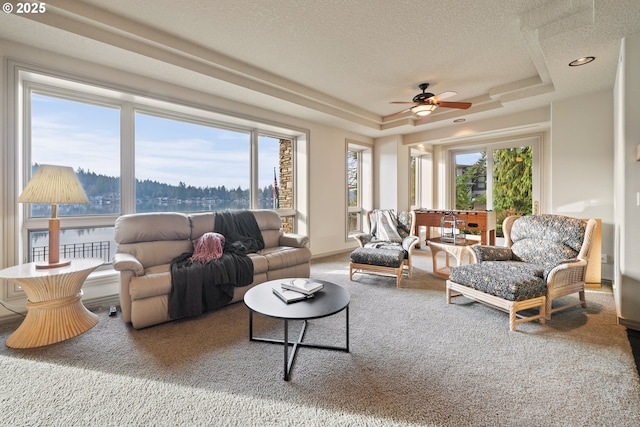 sunroom featuring ceiling fan and a tray ceiling