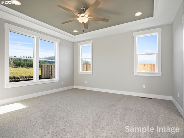 carpeted spare room with baseboards, recessed lighting, a ceiling fan, and a tray ceiling