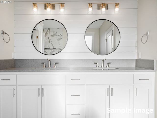 full bath featuring double vanity and a sink