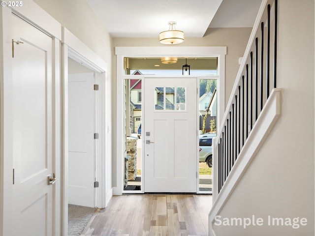 entryway with wood finished floors