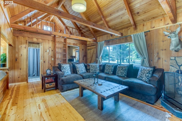 56095 Black Duck Rd, Bend, OR 97707 - living area with wood walls, light wood-type flooring, wooden ceiling with exposed beams, and high vaulted ceiling