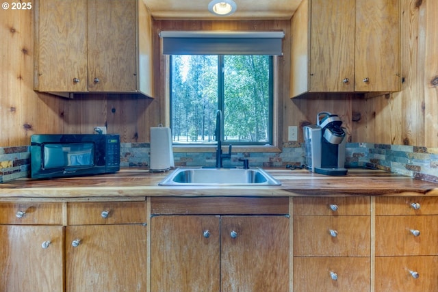 56095 Black Duck Rd, Bend, OR 97707 - kitchen featuring a sink and brown cabinets