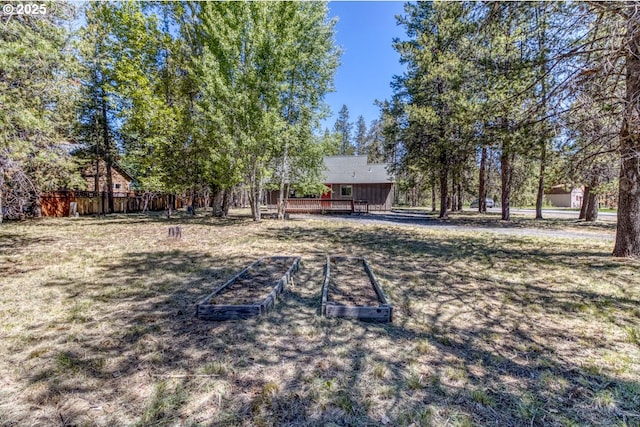 56095 Black Duck Rd, Bend, OR 97707 - view of yard featuring a garden and a wooden deck