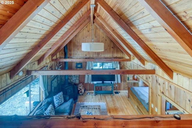 56095 Black Duck Rd, Bend, OR 97707 - living area with wood ceiling, a wood stove, wooden walls, hardwood / wood-style flooring, and stairs