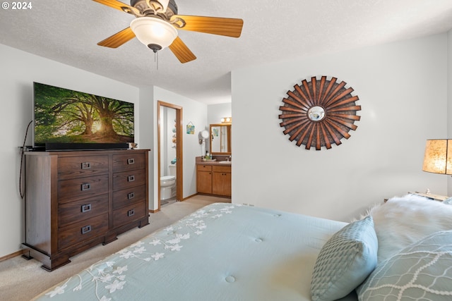 2097 Heather Way, Woodburn, OR 97071 - bedroom with light colored carpet, ensuite bath, a ceiling fan, baseboards, and a textured ceiling