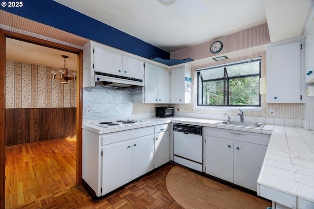 7450 SW Wilson Ave, Beaverton, OR 97008 - kitchen featuring white appliances, a sink, tile counters, a wainscoted wall, and wooden walls