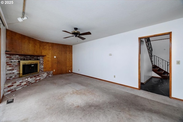 7450 SW Wilson Ave, Beaverton, OR 97008 - unfurnished living room featuring carpet, a ceiling fan, baseboards, stairway, and wooden walls