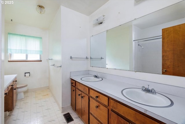 7450 SW Wilson Ave, Beaverton, OR 97008 - bathroom featuring toilet, double vanity, baseboards, a shower, and tile patterned floors