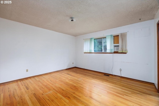 7450 SW Wilson Ave, Beaverton, OR 97008 - empty room featuring light wood-style floors and a textured ceiling