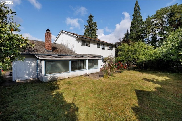 7450 SW Wilson Ave, Beaverton, OR 97008 - back of property featuring a yard, a chimney, a sunroom, and stucco siding