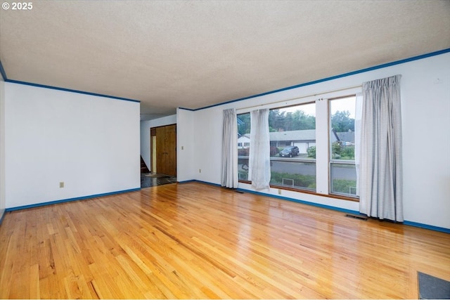 7450 SW Wilson Ave, Beaverton, OR 97008 - spare room with wood finished floors, baseboards, stairway, and a textured ceiling