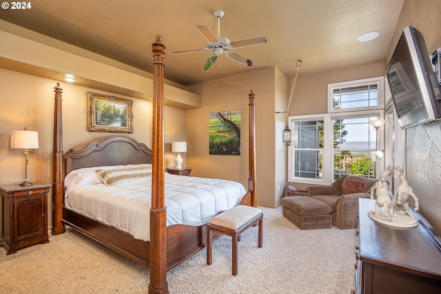 bedroom with light colored carpet and ceiling fan