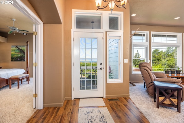 foyer entrance featuring visible vents, baseboards, and wood finished floors