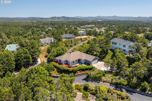 aerial view with a mountain view and a view of trees