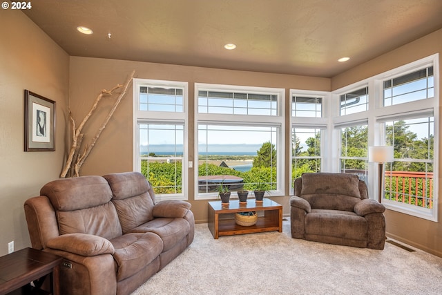 living room with visible vents, recessed lighting, and carpet