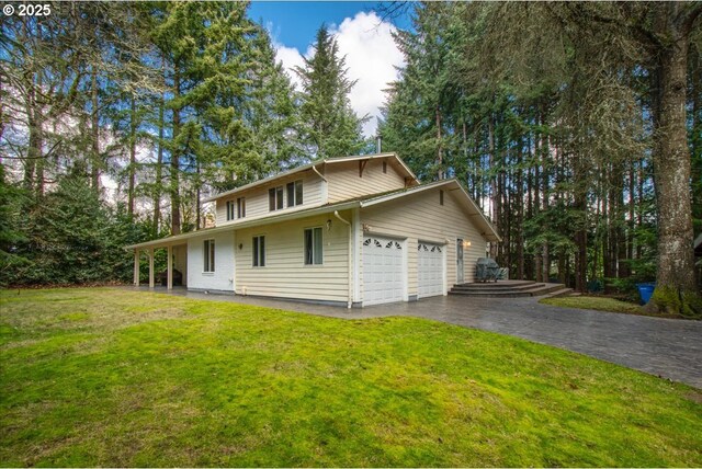 view of front of property with a garage and a front yard