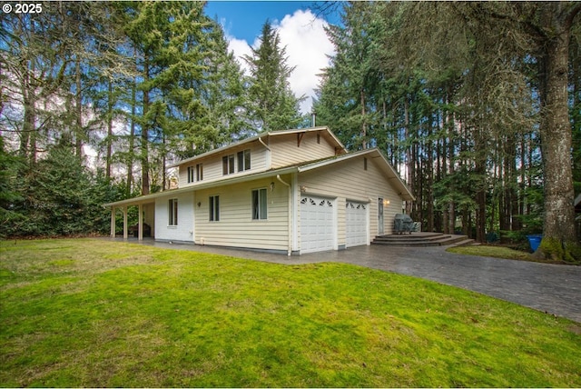 view of front of property featuring a garage and a front lawn