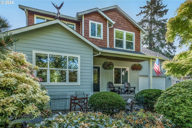 view of front of property featuring a porch and a garage