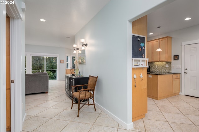 hallway featuring light tile patterned floors, recessed lighting, and baseboards