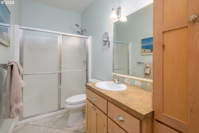 full bath with toilet, a stall shower, tile patterned flooring, and vanity