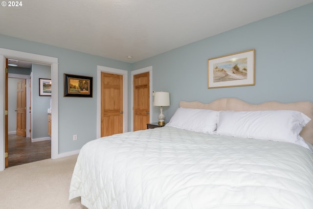 carpeted bedroom featuring baseboards